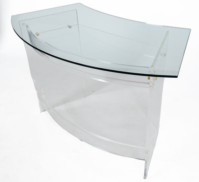 a clear glass table with a curved glass top