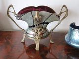 a silver vase and a blue vase sitting on a table