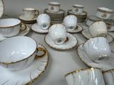 a lot of cups and saucers on the table