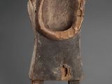 an old wooden sculpture of a man with a hat on his head