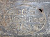 a close up of a rusted iron plate with a bird on it