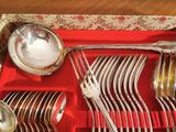 a red tray with silverware and spoons on it