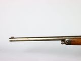 an old rifle with a wooden handle on a white background