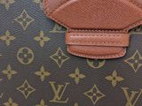 an image of a brown louis vuitton bag on a white background