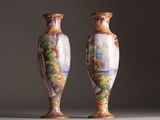pair of vases sitting on top of a white table next to each other