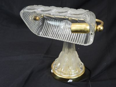 a glass and brass object on a black background