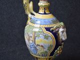 a blue and yellow vase with a bird on it