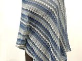blue and white striped ponchy on a mannequin stand