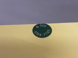 a green sign on the side of a yellow wall