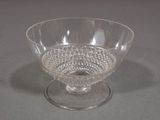 a clear glass bowl with beads in it on a table
