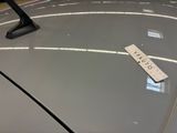 a sticker on the hood of a car with a name tag on it