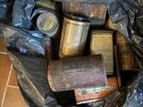 a black bag full of cans and tins on the floor