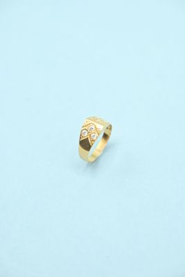 a close up of a gold ring on a white surface