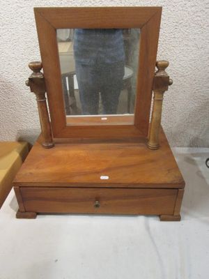 someone is taking a picture of a small wooden vanity with a mirror on it