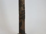 a tall vase with a bird on top of it