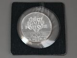 a silver coin with a picture of the olympic logo on it