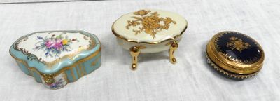 three small boxes are sitting on a table with a white table cloth