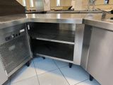 a stainless steel kitchen with a sink and a counter