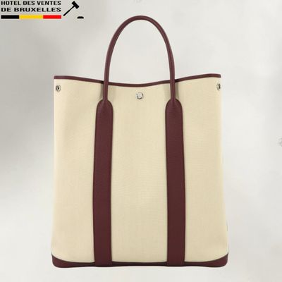 a white and brown tote bag sitting on top of a white table