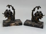 pair of antique bronze figurines of a man and a woman on a boat