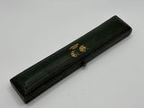 an image of a black pen with a gold emblem on it