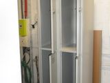 two metal lockers in a room with white walls