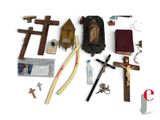 a collection of religious items including a crucifix, a book, scissors, and a knife