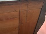 a wooden cabinet with a door on the top of it
