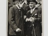 an old black and white photo of two men in top hats and tails