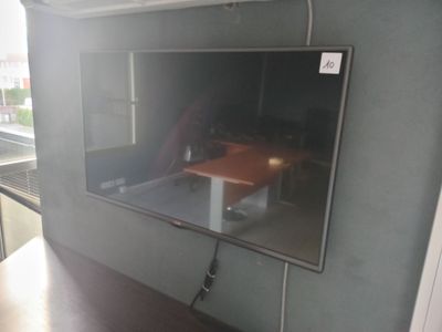 a flat screen tv mounted on a wall in a room
