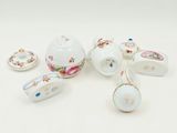 a group of porcelain objects sitting on a white surface