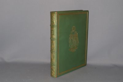 a green book sitting on a white surface
