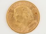 a close up of a gold coin on a white surface