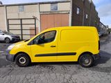 a yellow van parked in a parking lot next to a building