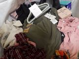 a suitcase full of clothes and other items sitting on a bed