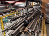 a large pile of steel rods in a warehouse