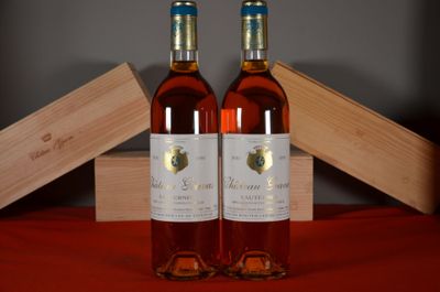 two bottles of wine sitting next to each other on a table
