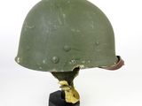 a green helmet on a black base on a white background