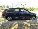 a picture of a small black car parked in a lot