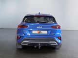 the rear end of a blue car in a white room