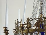 a blue glass chandelier hanging from a gold chandelier