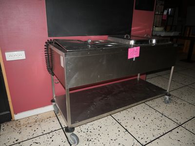 a stainless steel table with a sink on top of it
