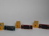 several toy trains are lined up next to each other on a white surface