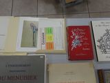many books that are on a table on the floor