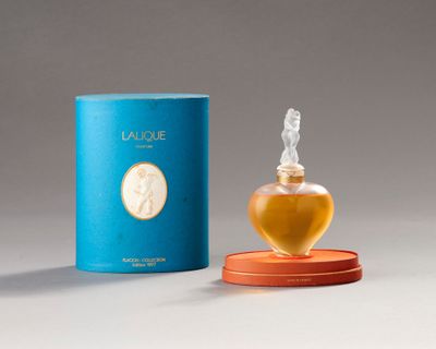 an image of a bottle of perfume sitting on top of a table