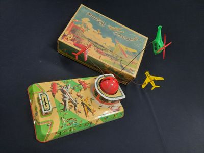 a small tin box with a game on it and a toy airplane