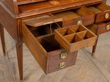 a wooden desk with drawers and a clock on it