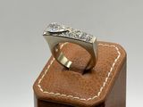 an image of a diamond ring on a wooden stand