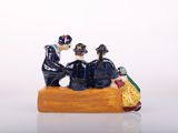 a figurine of a group of people sitting on a bench