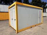 an image of a portable toilet in a parking lot
